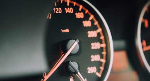 A close up of a speedometer in a car